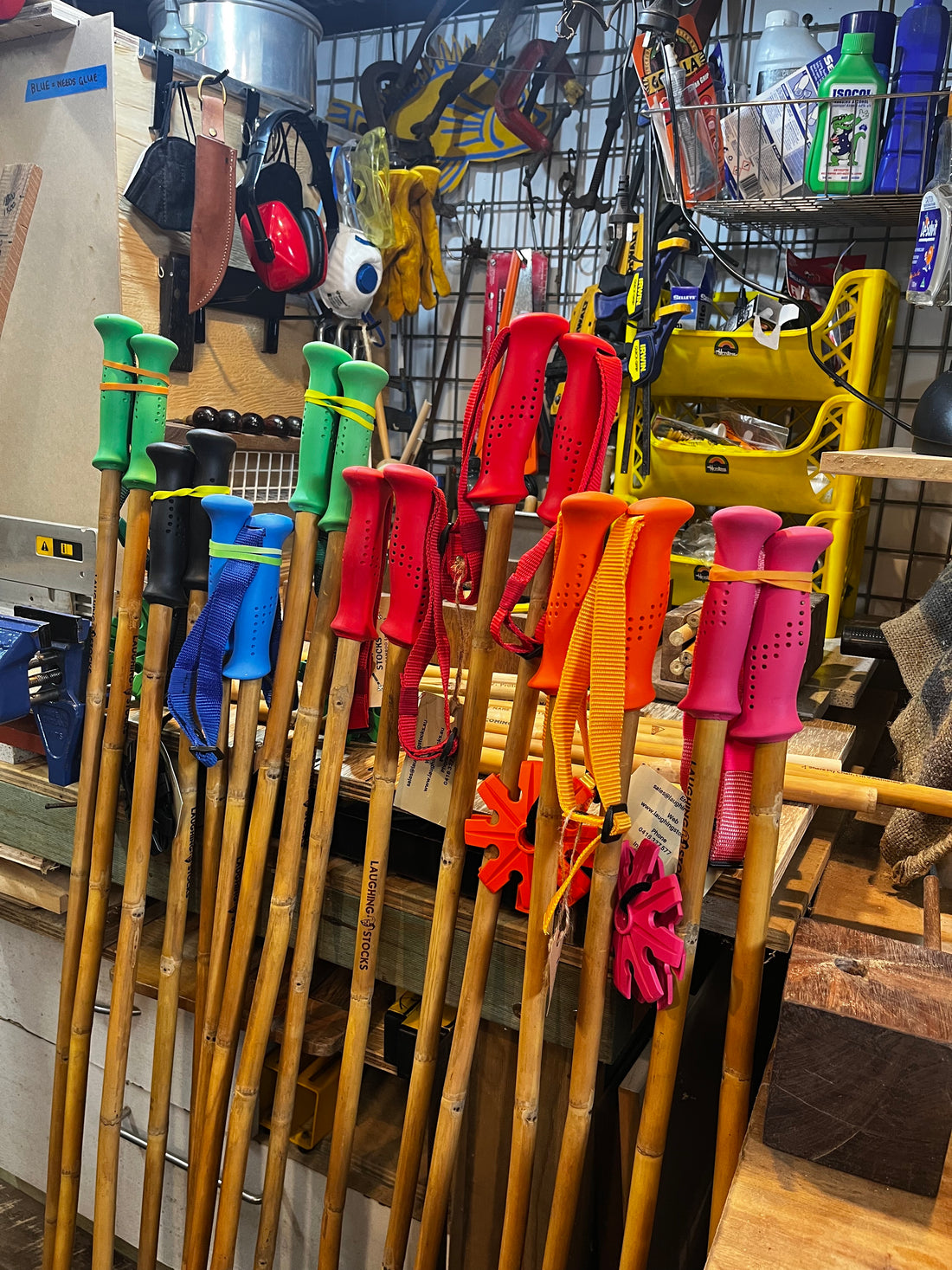 photo of workshop showing bamboo ski poles with a range of colourful handles in the foreground